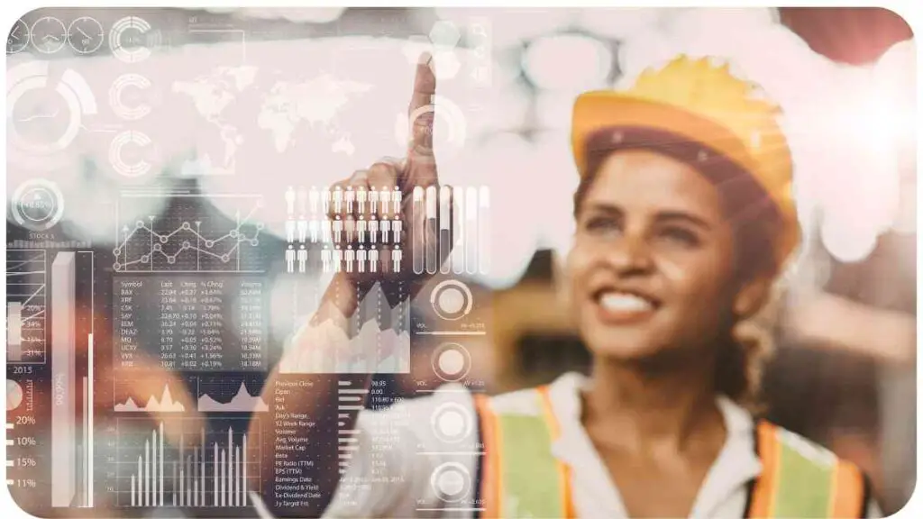 a person in a hard hat pointing at a computer screen