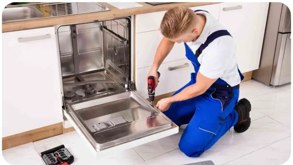 a person fixing a dishwasher in a kitchen