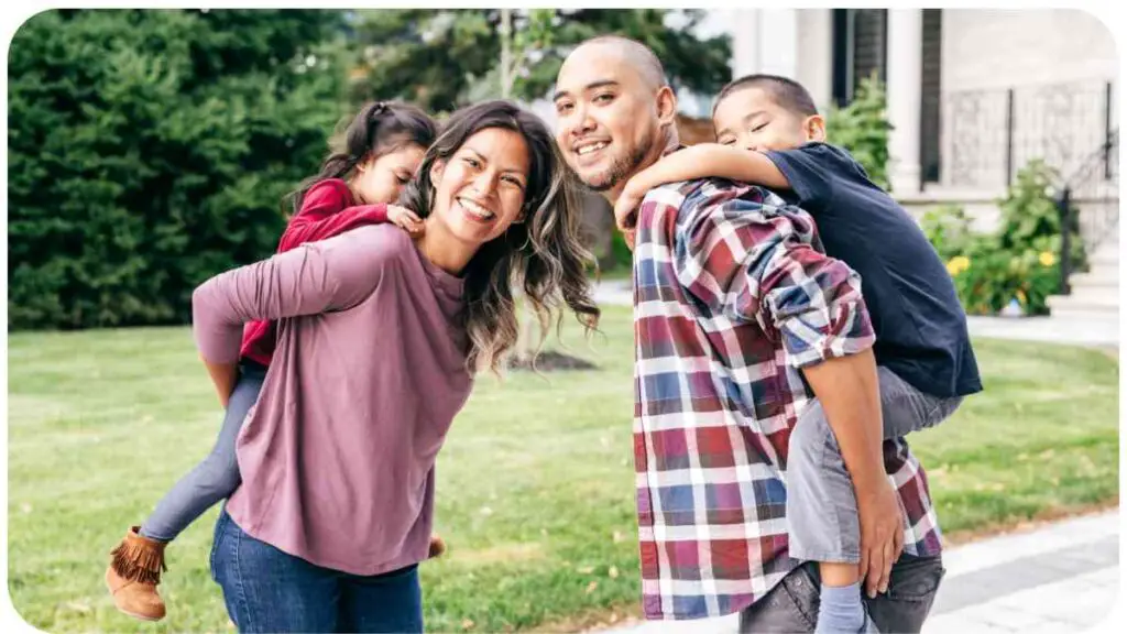 a group of people with two children are standing in front of a house.