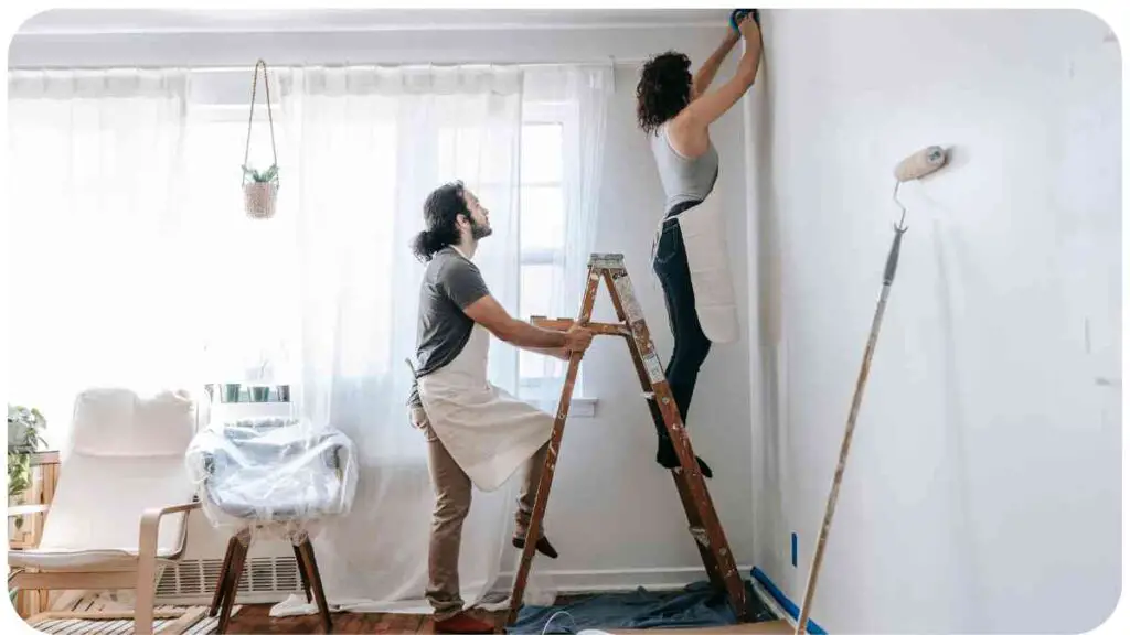 a person and another person are painting a room