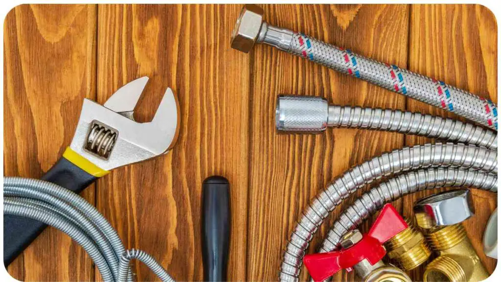 various plumbing tools laid out on a wooden table