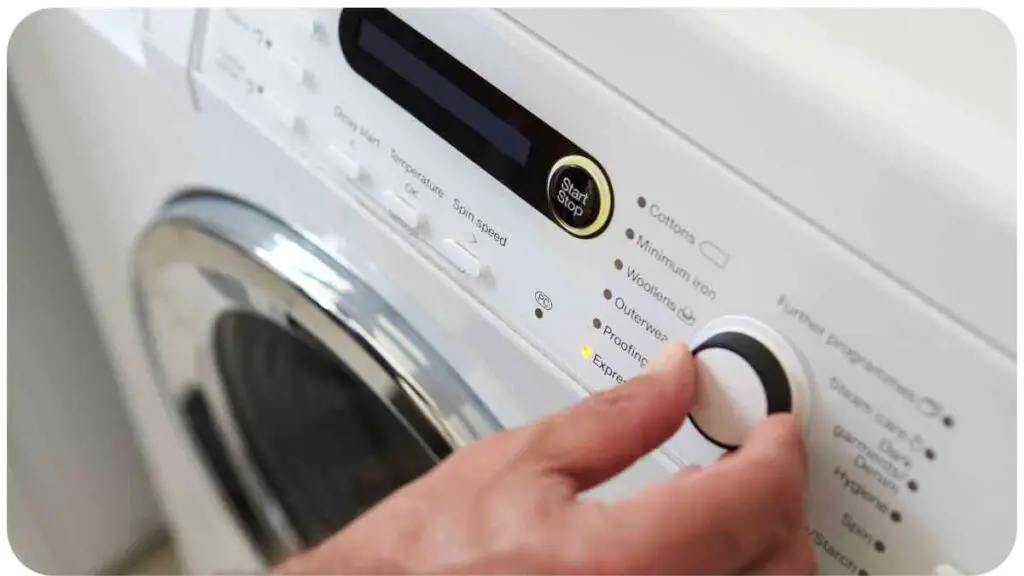 a person is pressing a button on a washing machine